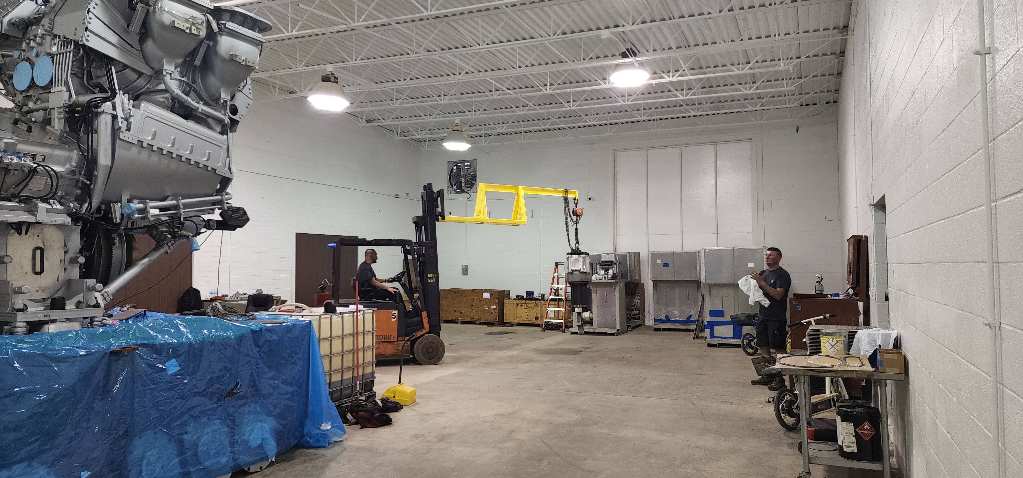 AirBorn Manufacturing project staging area with large equipment and shop floor space.