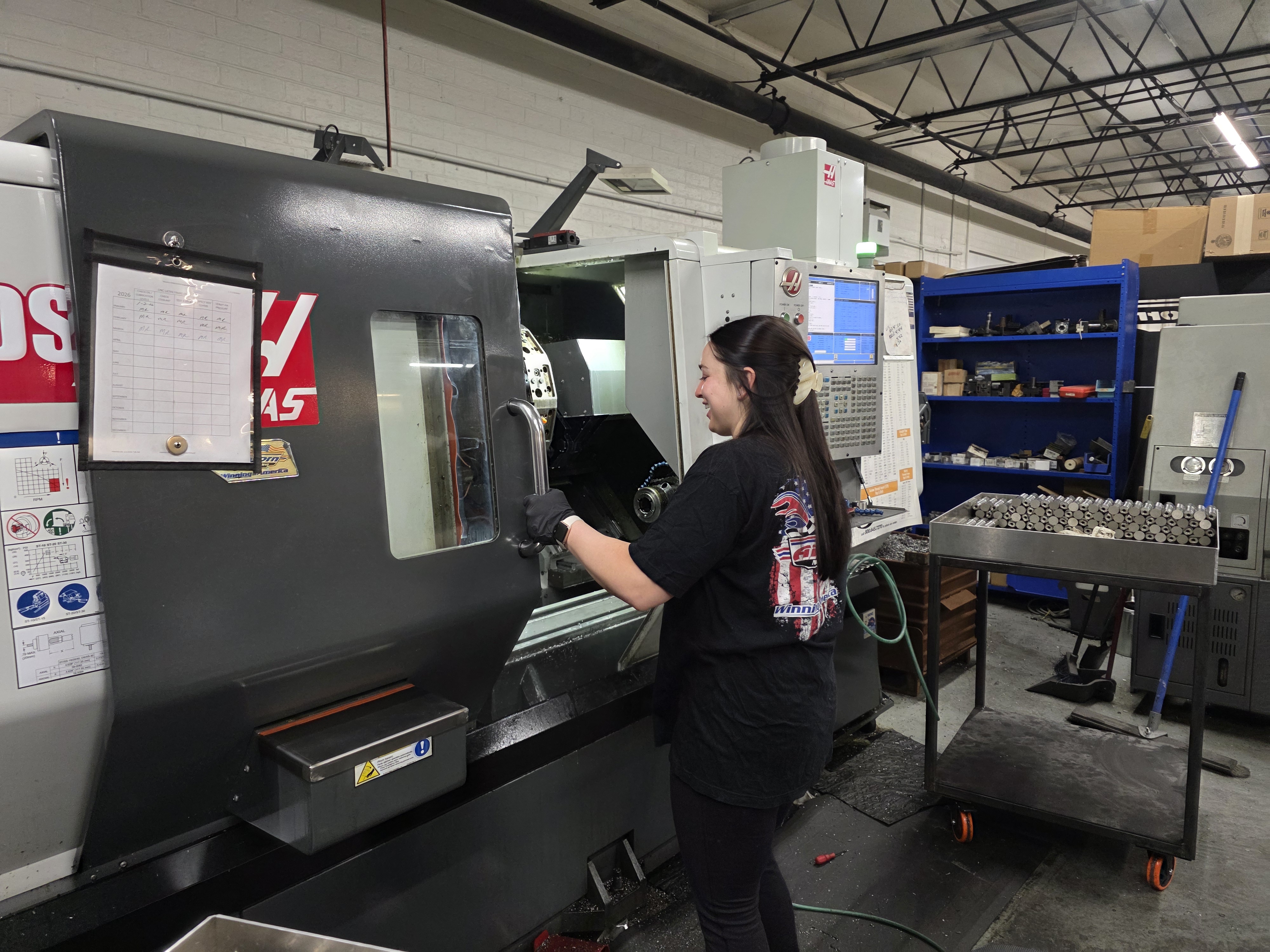 Operator working at a CNC lathe production cell inside AirBorn Manufacturing.