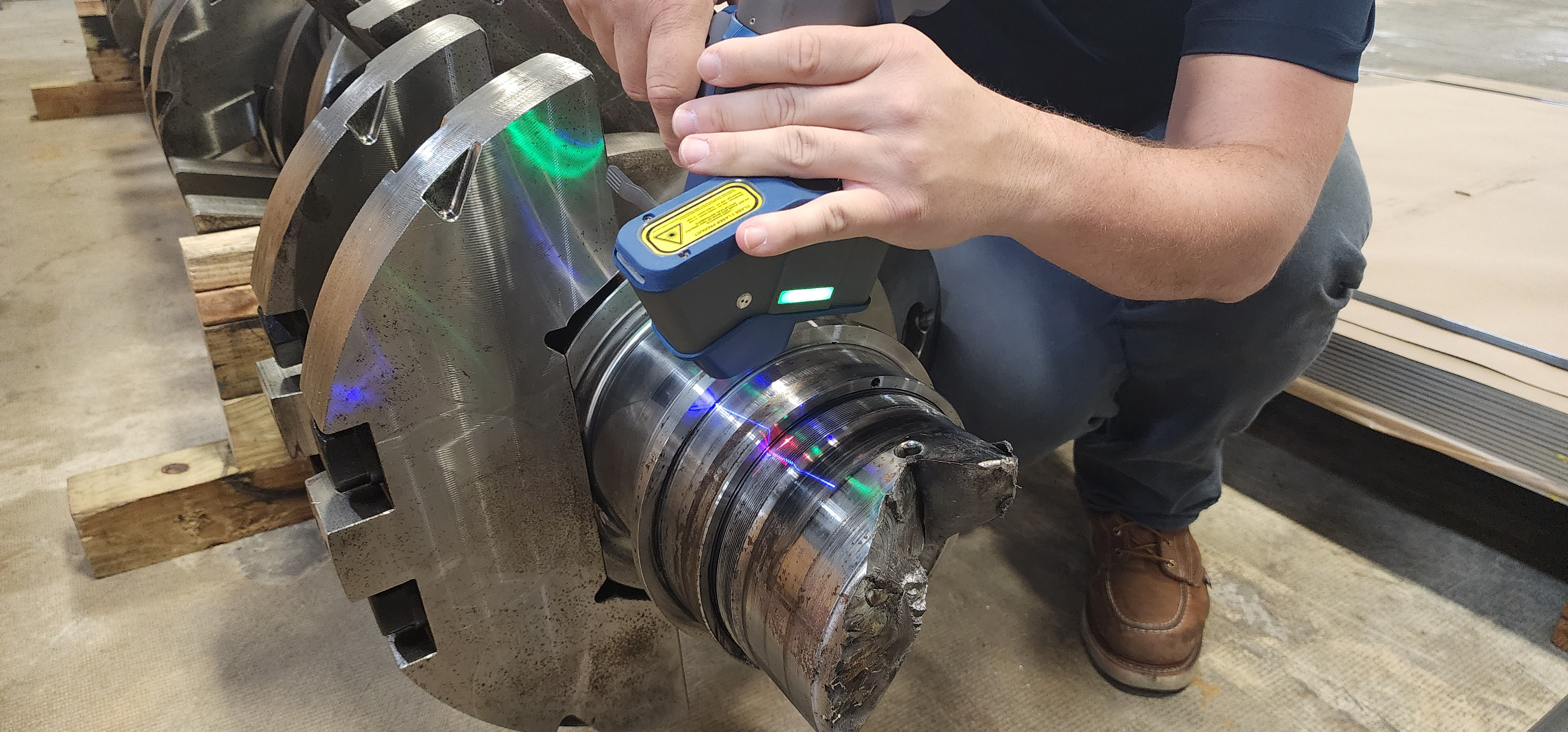 Dimensional inspection of a machined metal shaft using a handheld measuring tool.