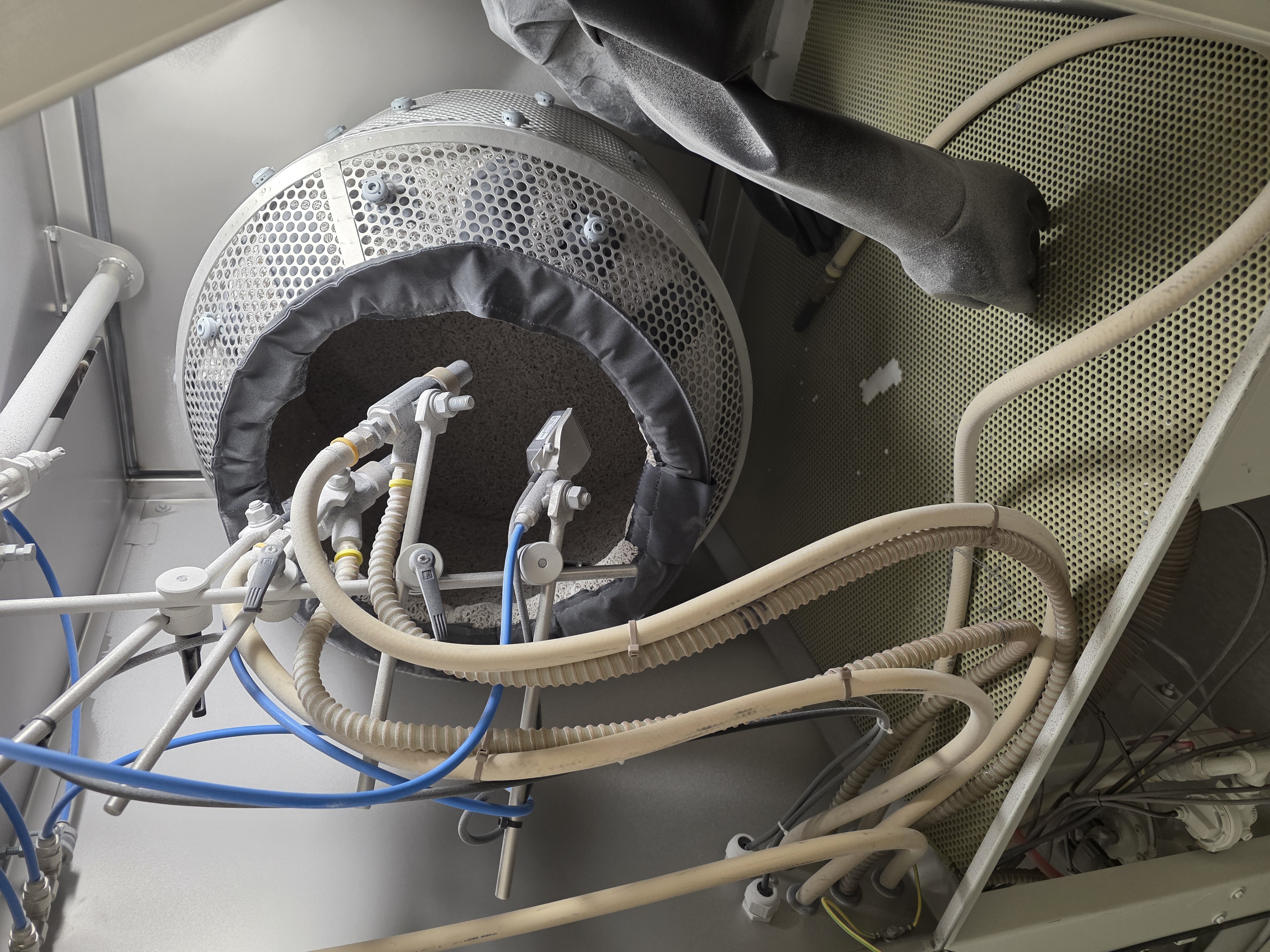 Industrial shop fixture and hose detail used around manufacturing equipment.
