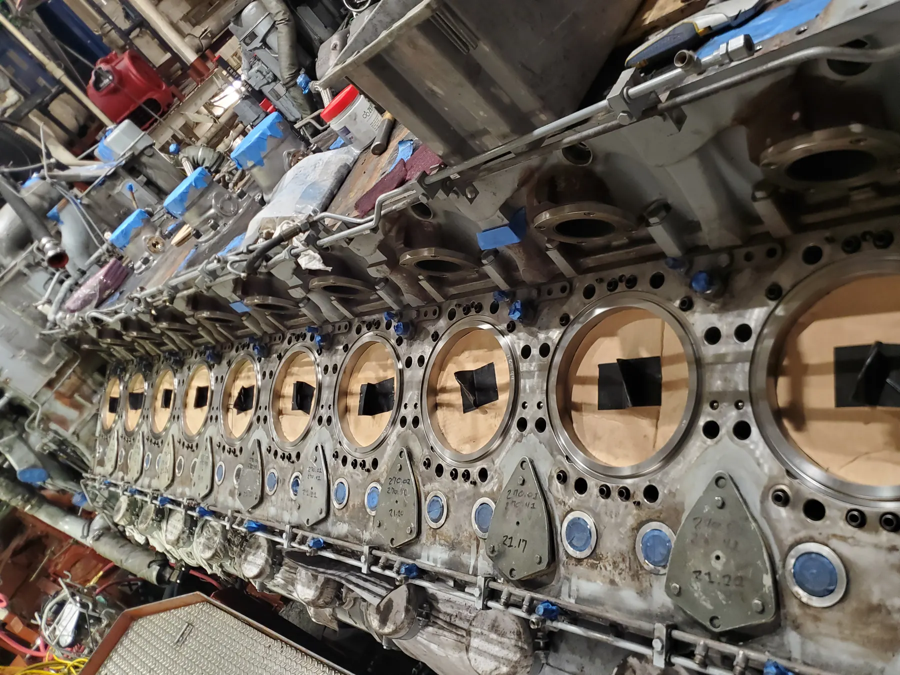 Large engine block component with machined circular openings and cover locations.
