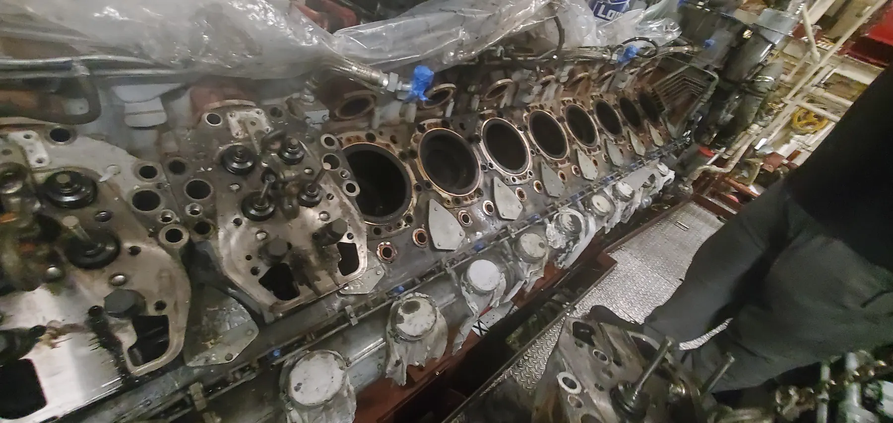 Large engine component service detail showing machined circular openings and assembly features.