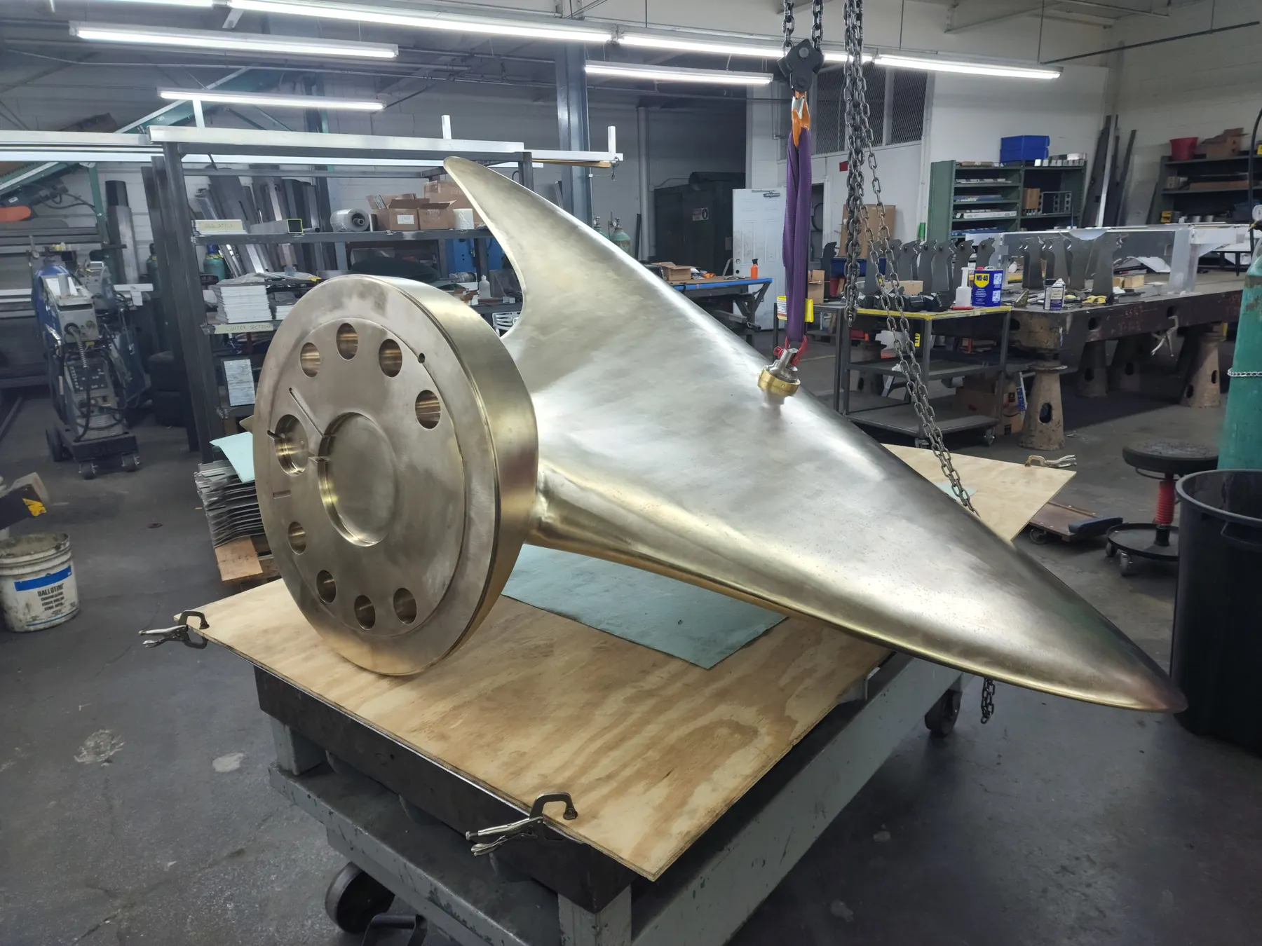 Large formed metal component staged for final shop review.