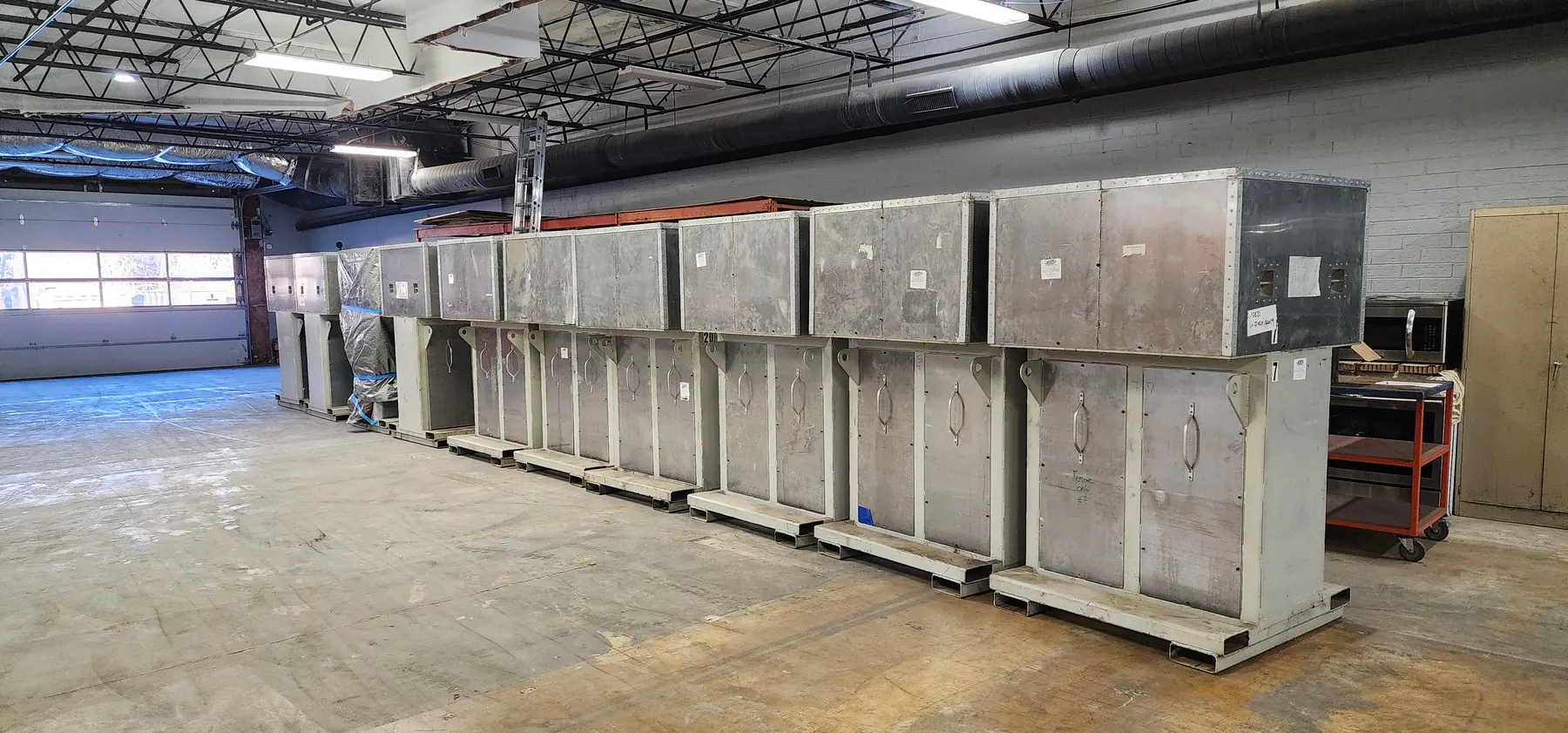 Large sheet metal fabricated ductwork staged in a production area.