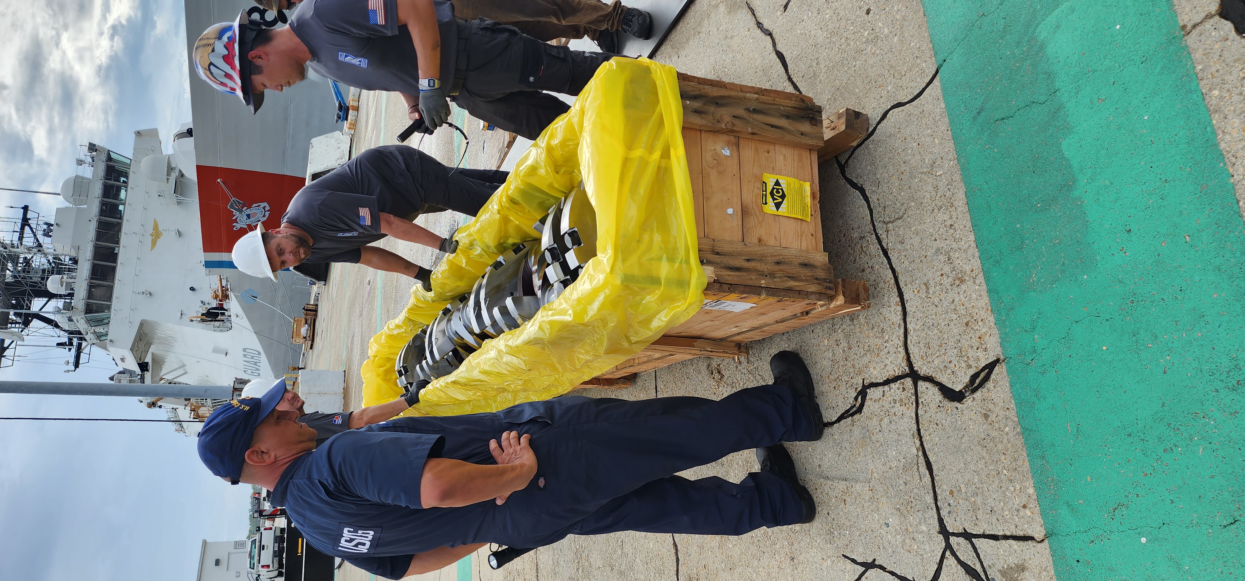 Machined metal shaft prepared for installation with protective covering nearby.