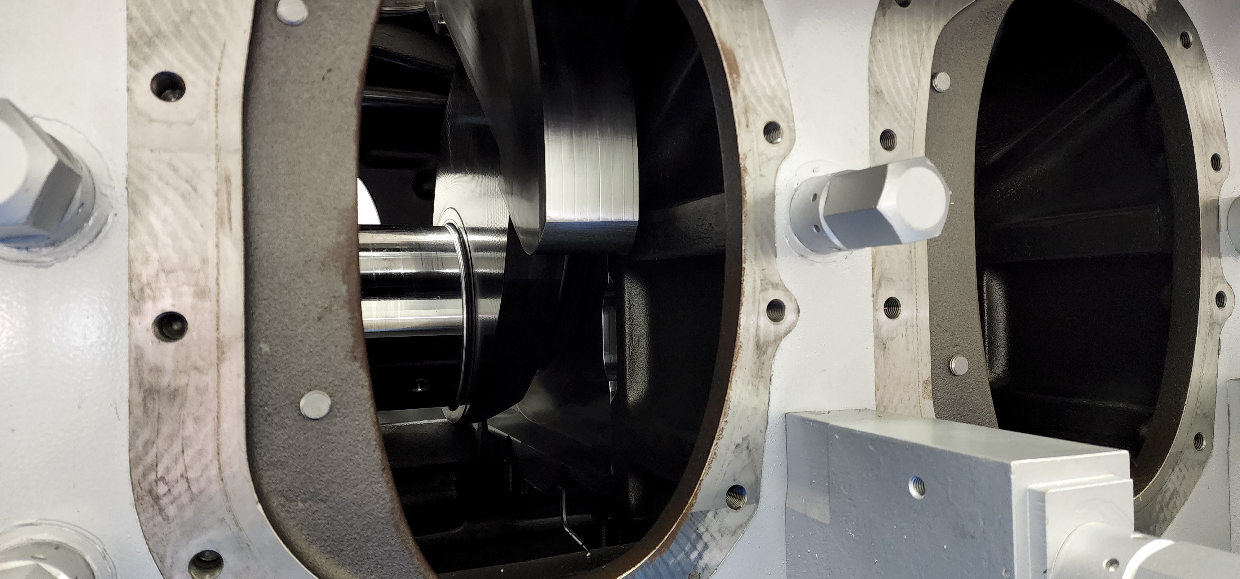 Machined rotor housing detail with polished rotating component visible inside.