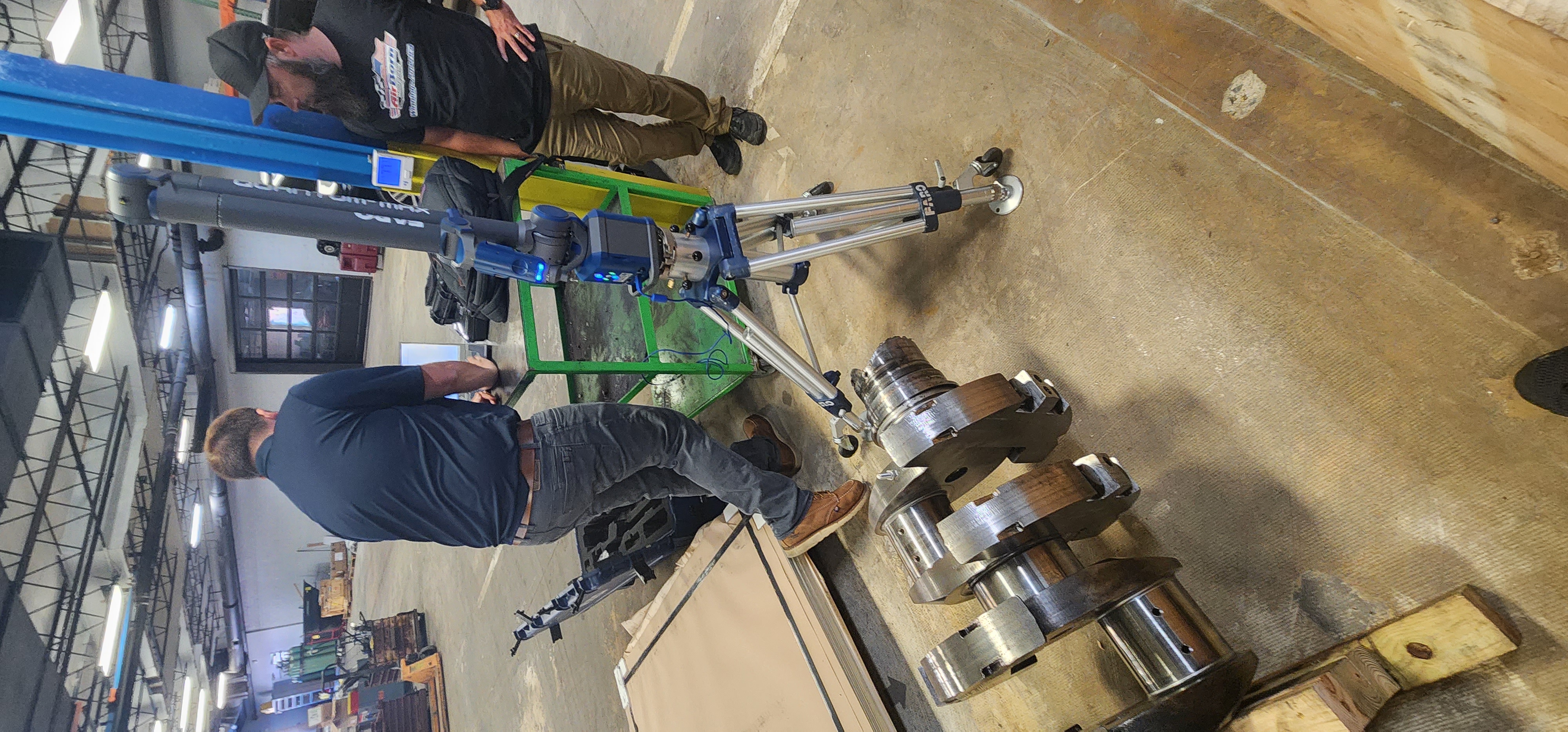 Machined shaft assembly positioned for inspection and fit review.