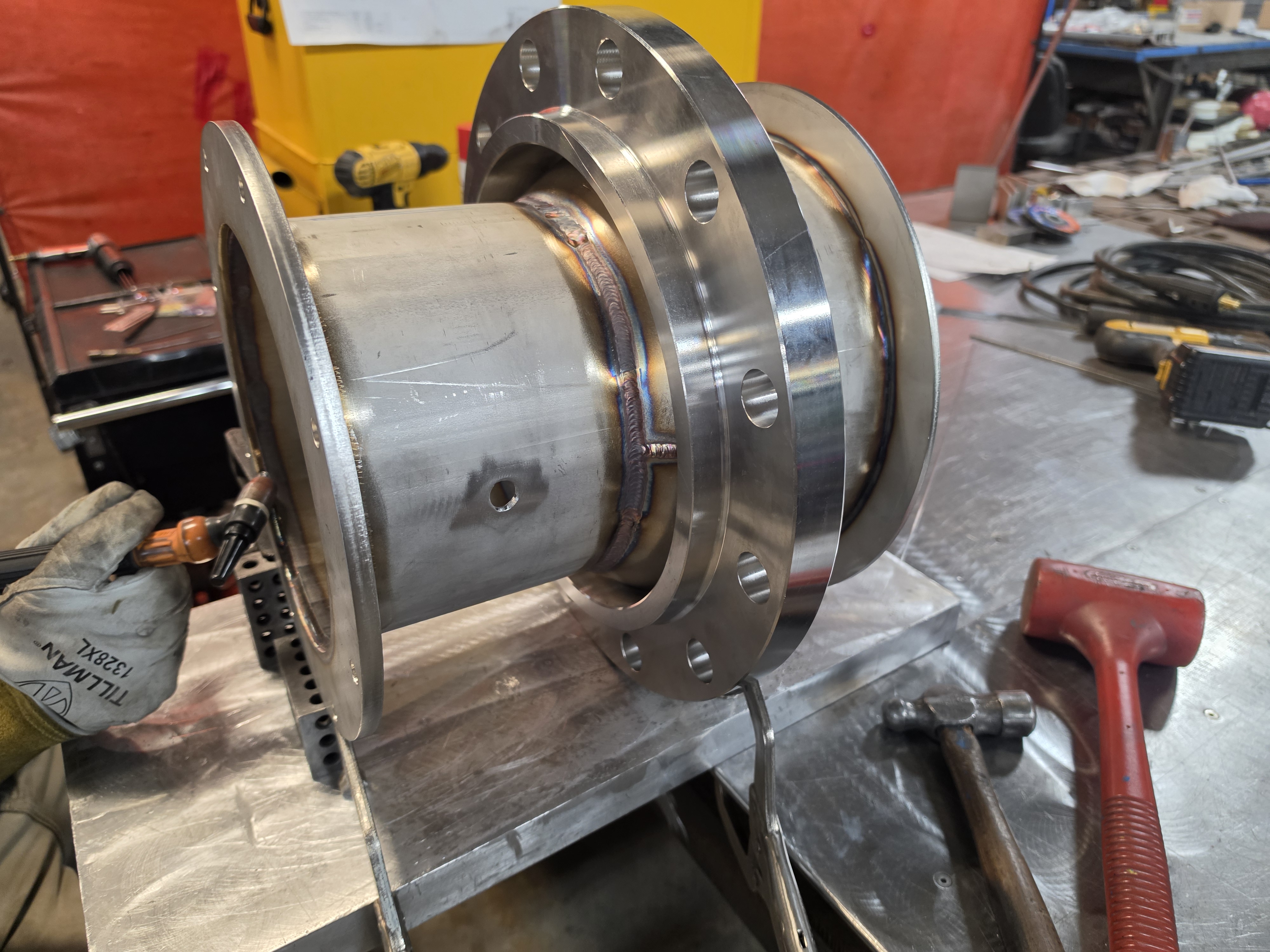Machined steel cylinder assembly detail on a workbench.