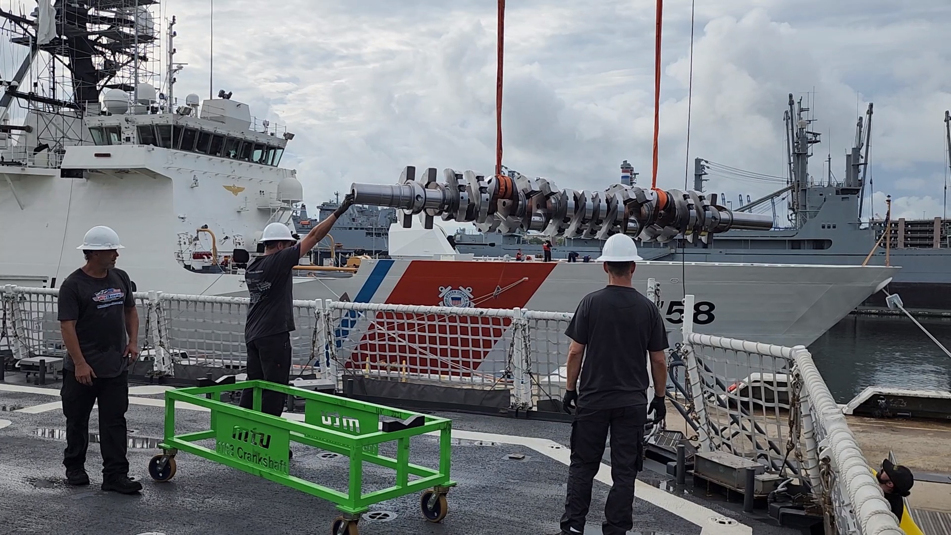 Marine field fabrication equipment being lifted near a vessel.