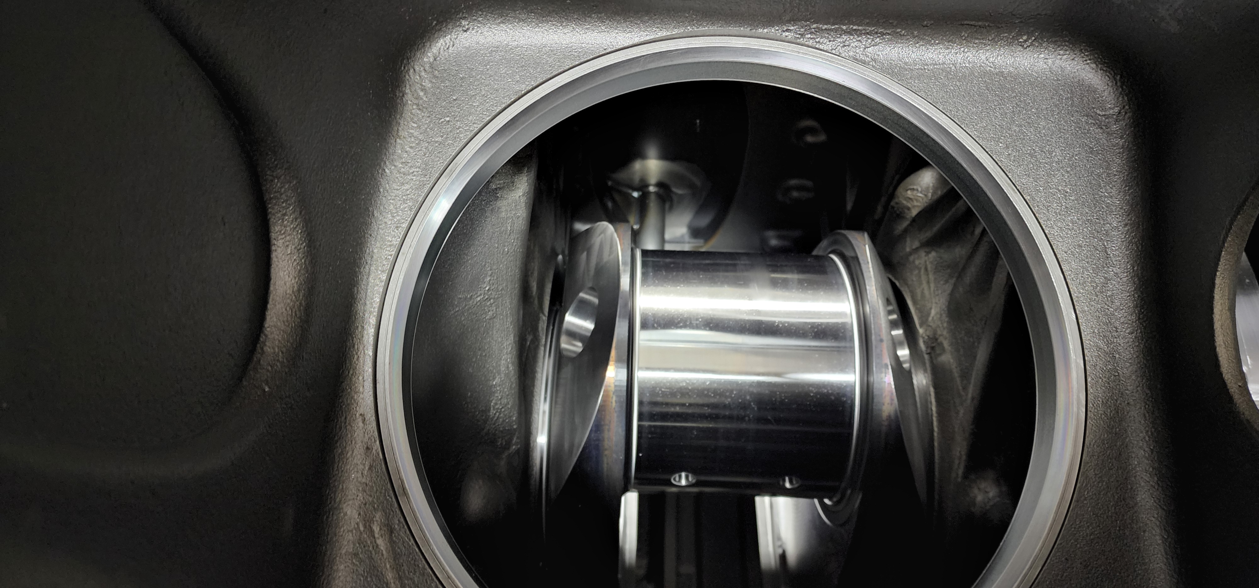 Polished machined cylinder visible inside a metal housing.