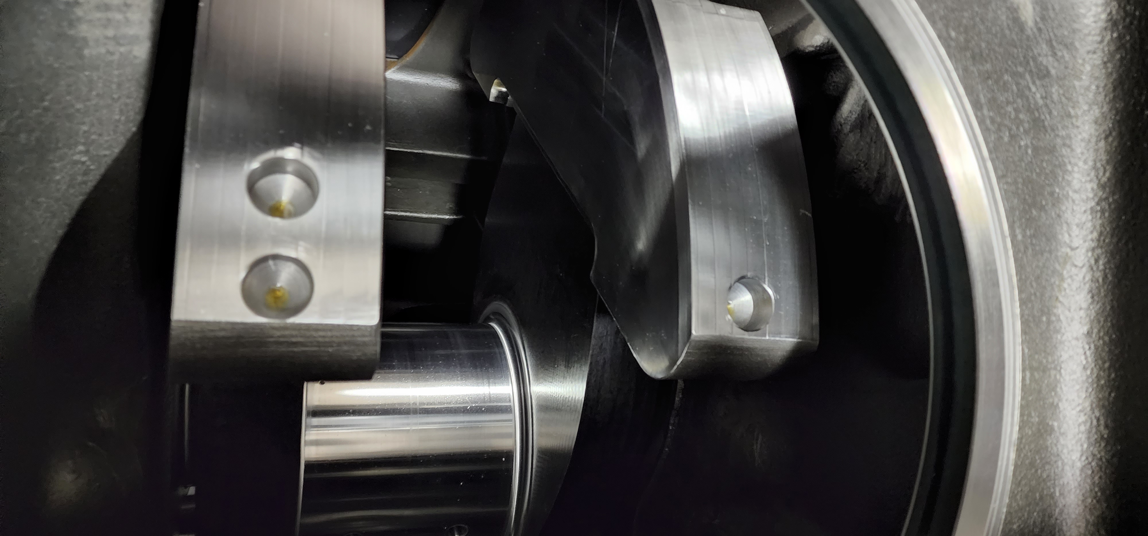 Polished machined metal hub detail inside a larger mechanical assembly.