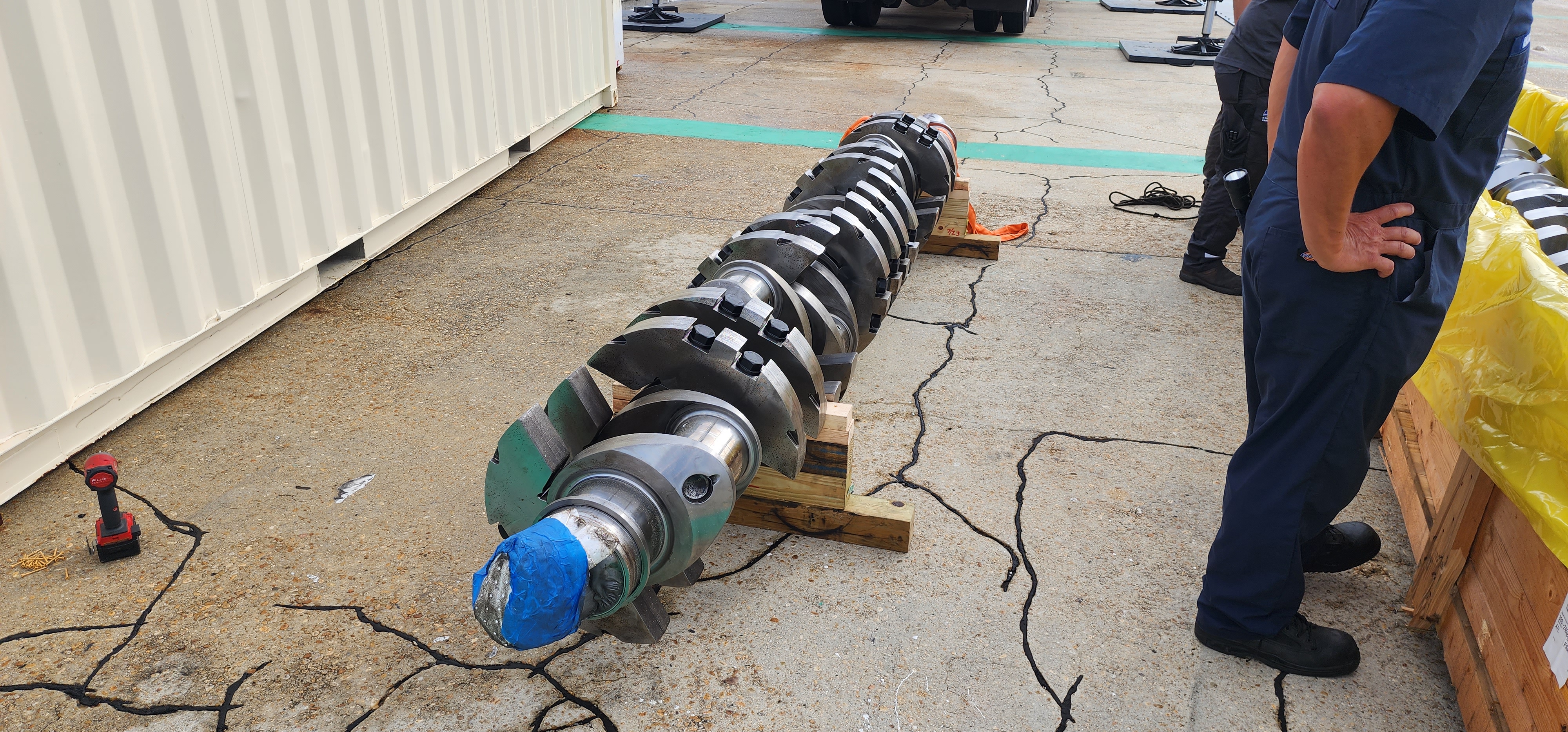 Precision turned metal shaft assembly staged on the shop floor.