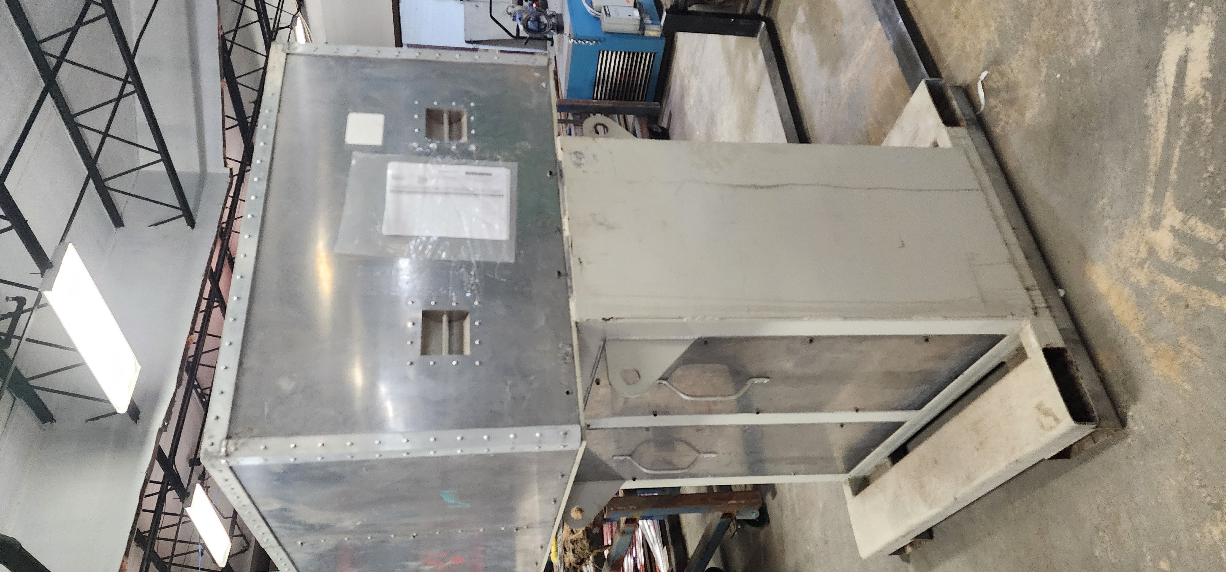 Fabricated sheet metal equipment panel with cutouts and formed features.