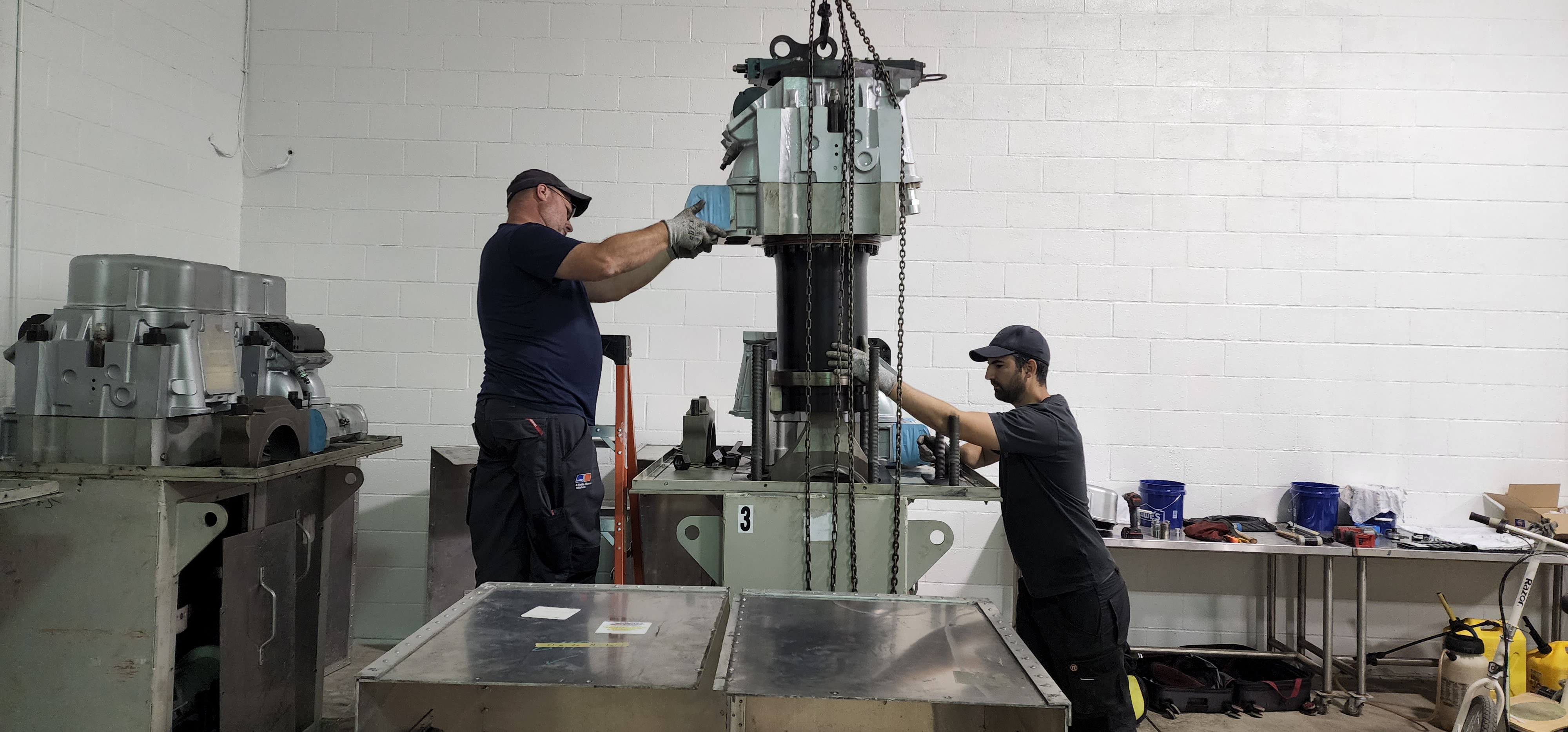 Vertical machined assembly positioned on a fixture setup in the shop.