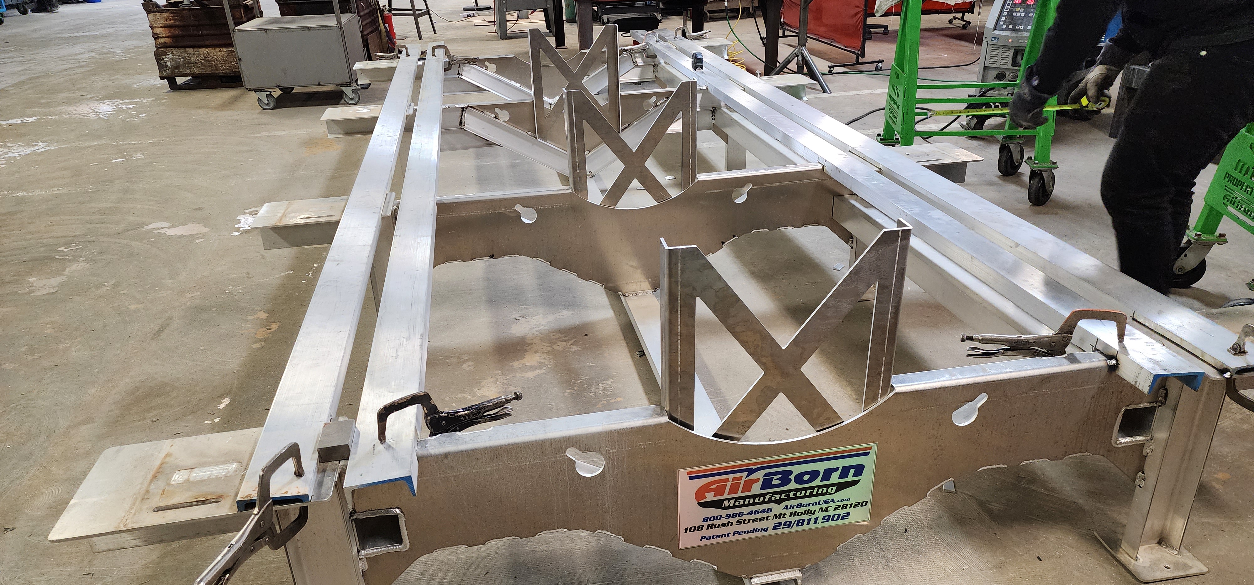 Welded aluminum frame fabrication assembly staged on the shop floor.