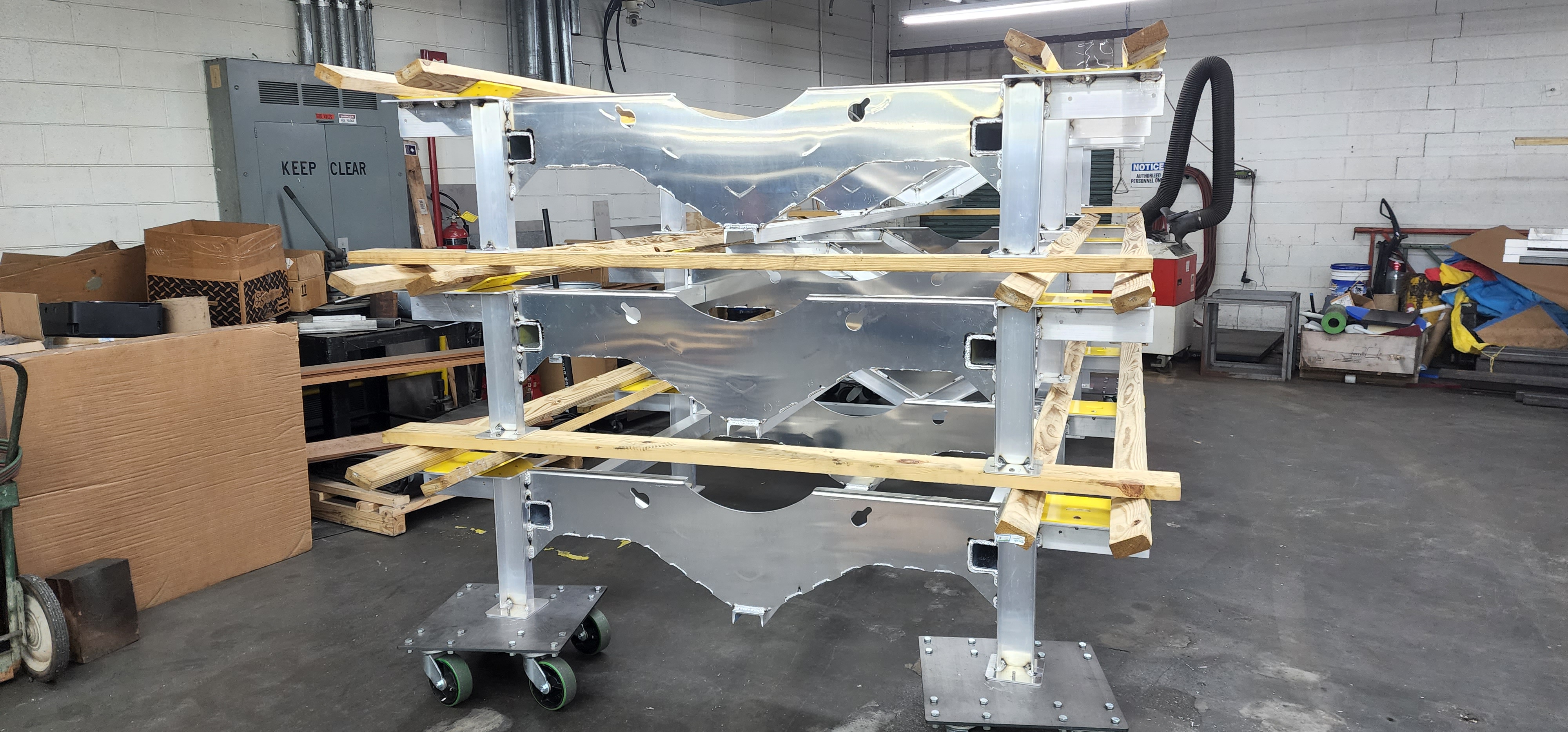 Wrapped fabricated metal frame secured on a shipping cart.
